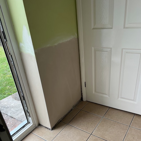 The same door reveal replastered and made good, meeting the existing paintwork in a clean line
